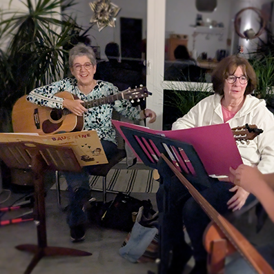zwei Seniorinnen spielen Gitarre